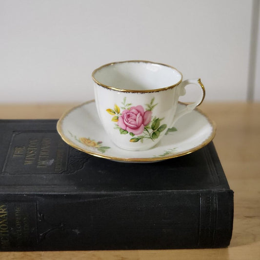 A tea cup and saucer resting on a book, creating a serene and cozy scene.