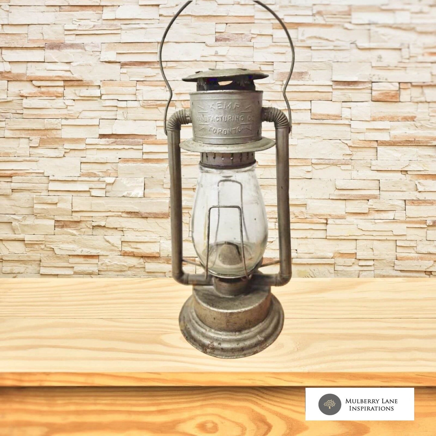 An antique lantern sits on a rustic wooden table, emanating a warm glow in a dimly lit room.