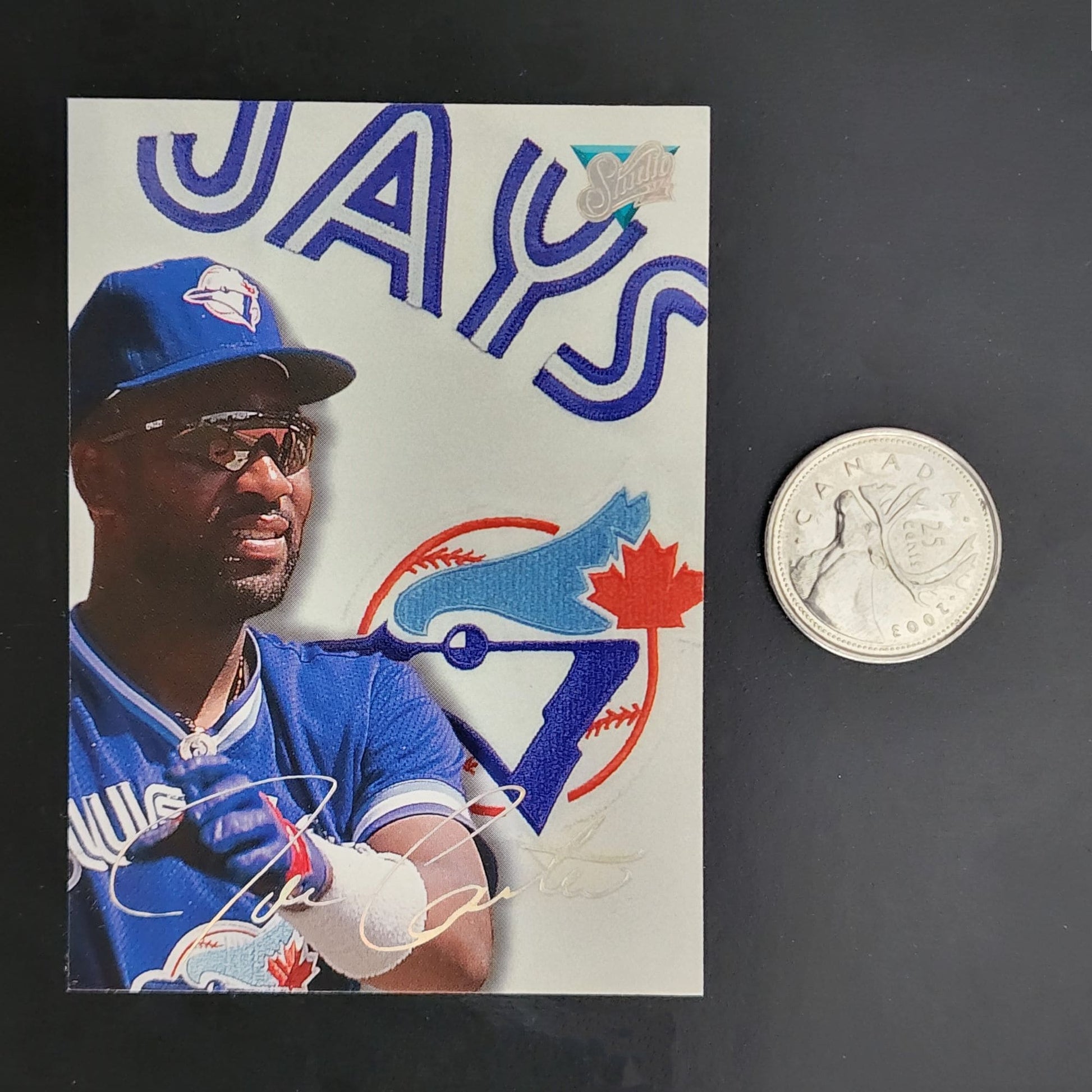 A baseball card featuring a coin beside it, showcasing a valuable collectible item.