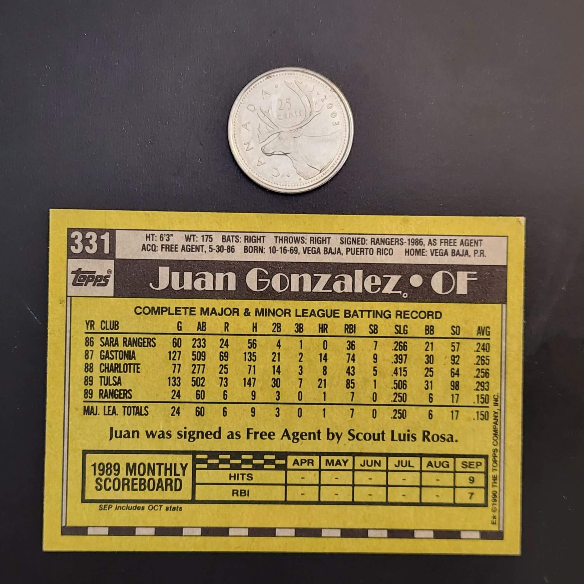 Baseball card featuring man with bat next to coin, vintage design, collectible sports memorabilia.