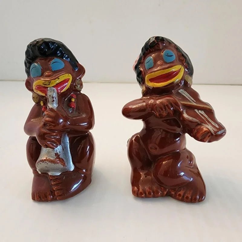 Two ceramic monkey figurines playing musical instruments, adding a touch of whimsy and charm to any space.