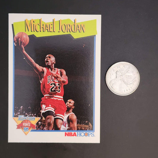 Michael Jordan basketball card with a quarter for size comparison.