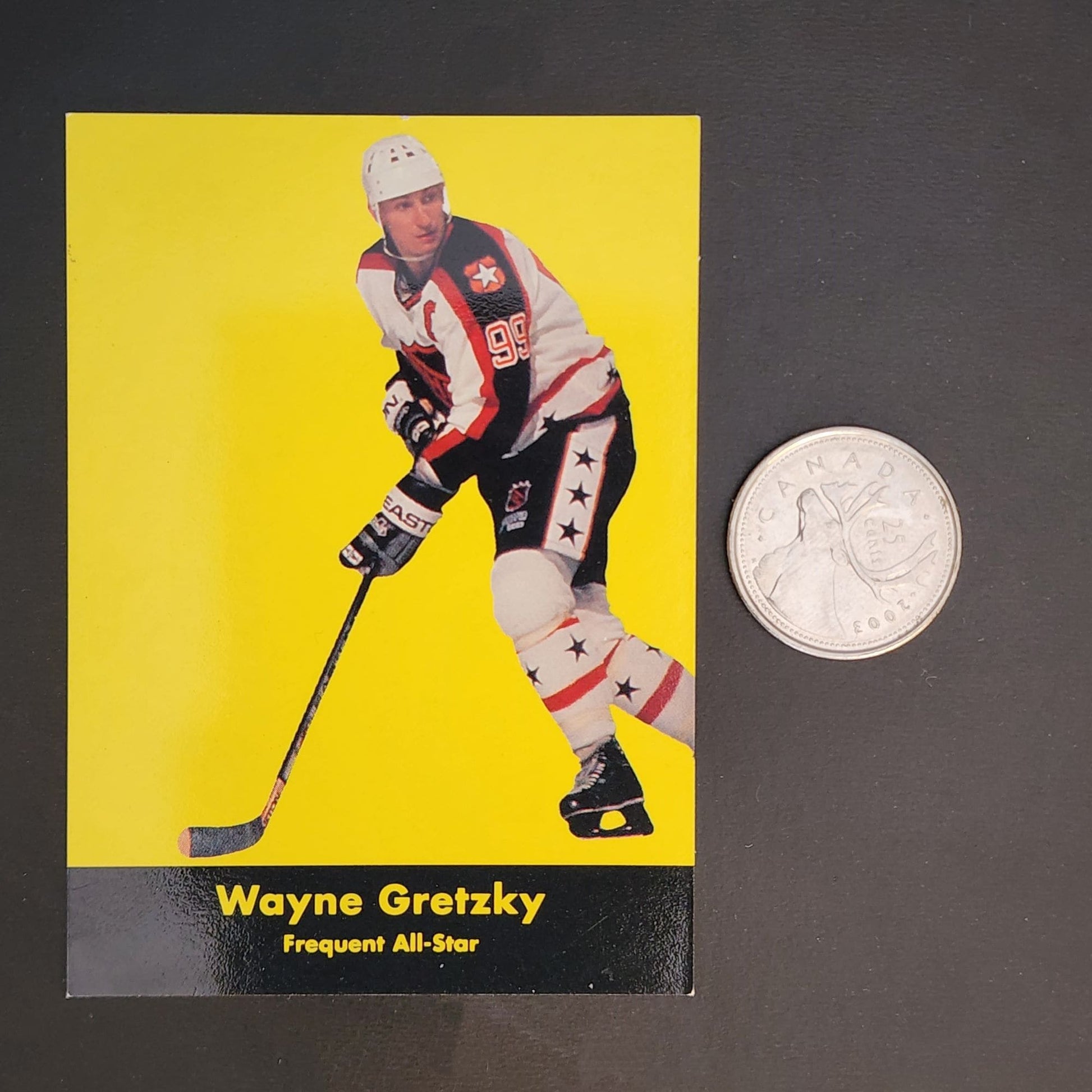 A hockey card featuring a coin placed beside it, showcasing the sport's memorabilia and potential value.