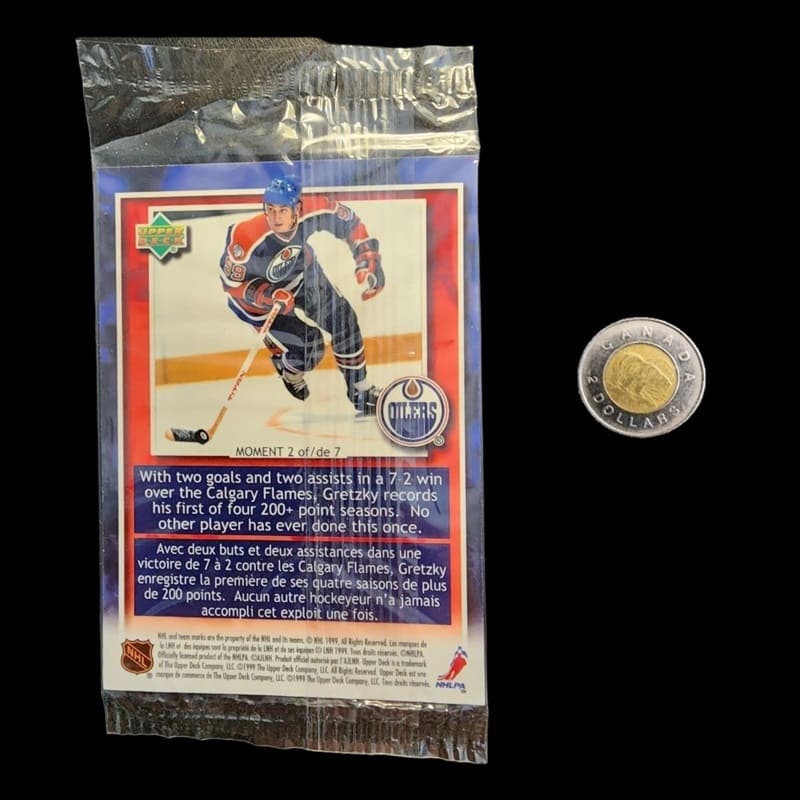 Hockey cards pack displayed with a coin for scale.