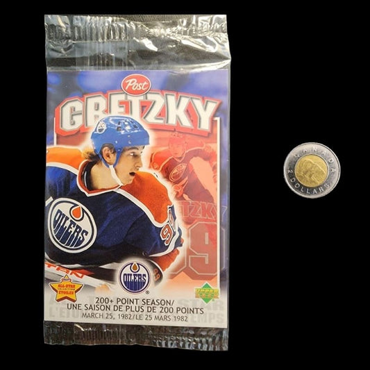 Hockey cards pack displayed with a coin for scale.