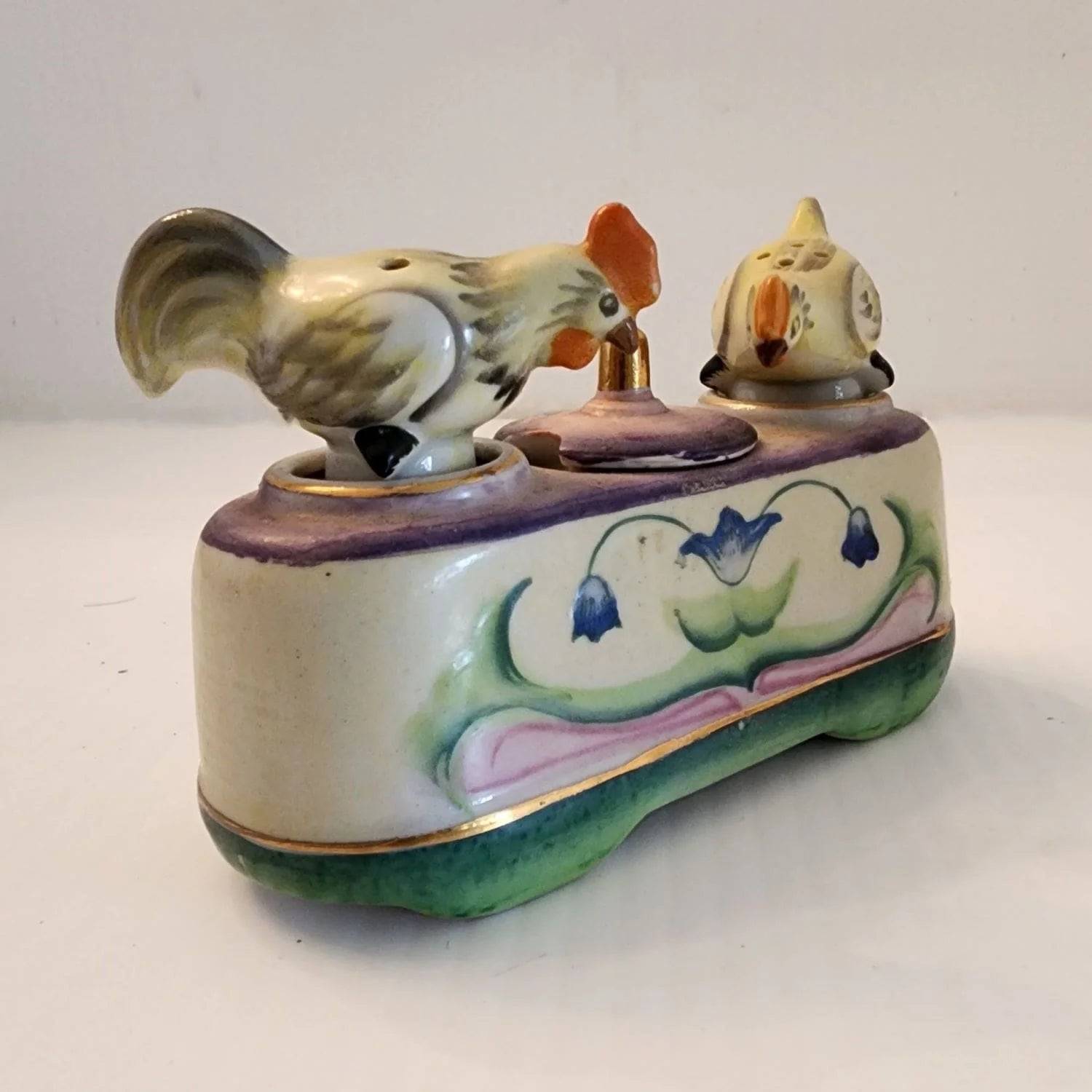 Ceramic box with two bobble birds on the top