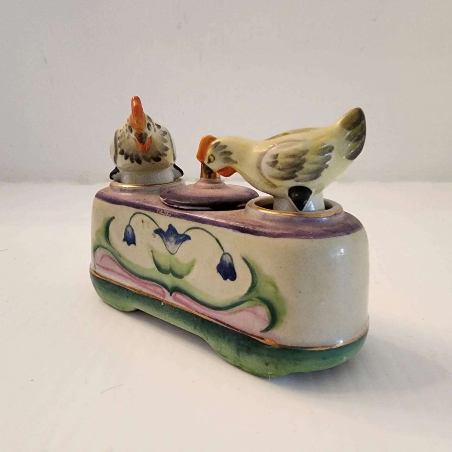 Ceramic box with two bobble birds on the top