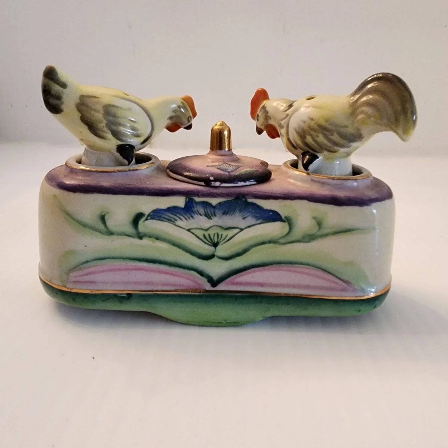 Ceramic box with two bobble birds on the top