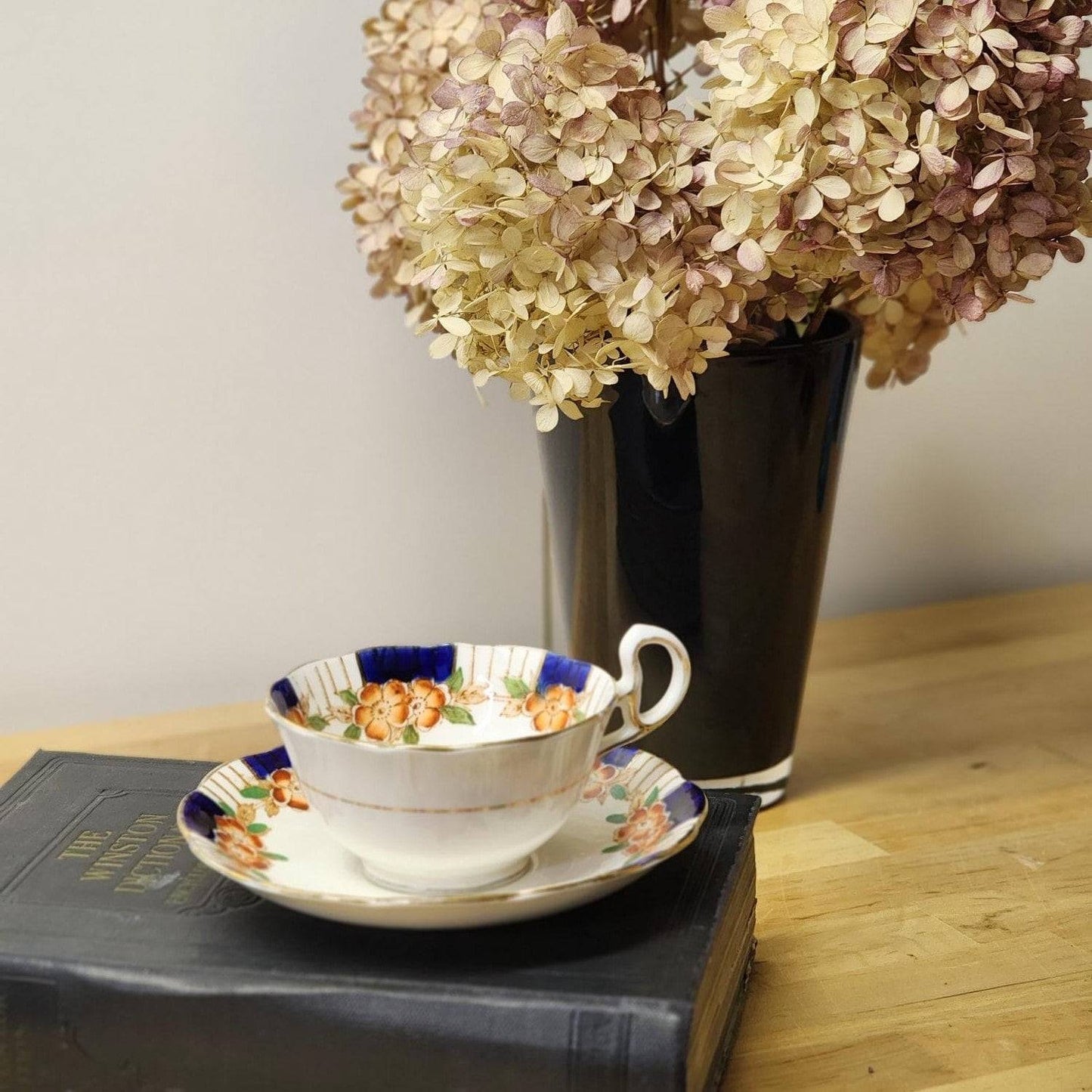 Vintage china cup and saucer featuring floral pattern.