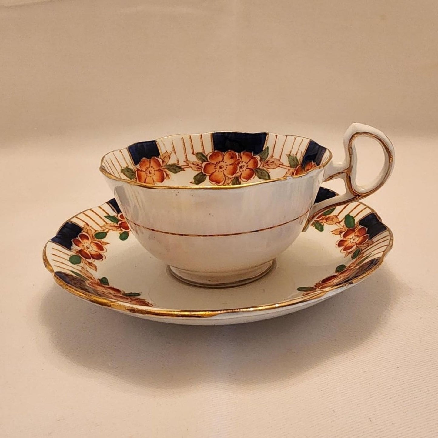 Vintage china cup and saucer featuring floral pattern.