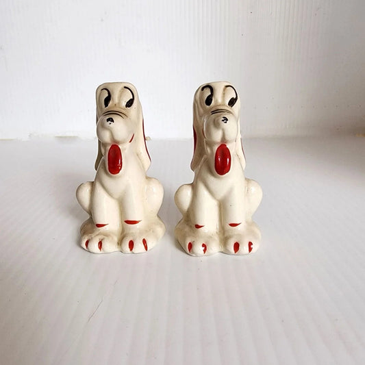 Pair of ceramic dog figurines with red noses, one seated and one standing, perfect for holiday decor.